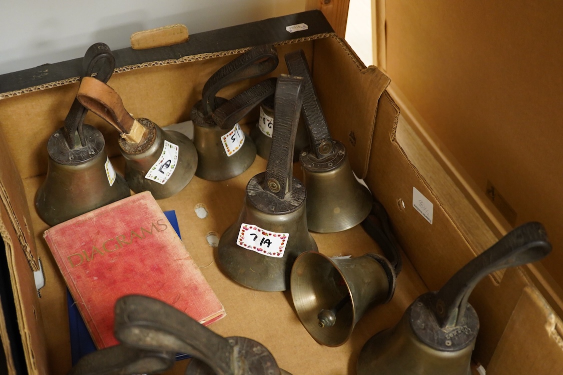 A set of twenty-two bronze handbells by Mears, London, with leather grips, together with two books from the Jasper Snowden Change Ringing Series, largest diameter 16cm